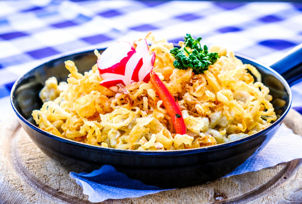 Traditional Swabian "Spätzle" noodles with fried onions and grated cheese called kaesespaetzle