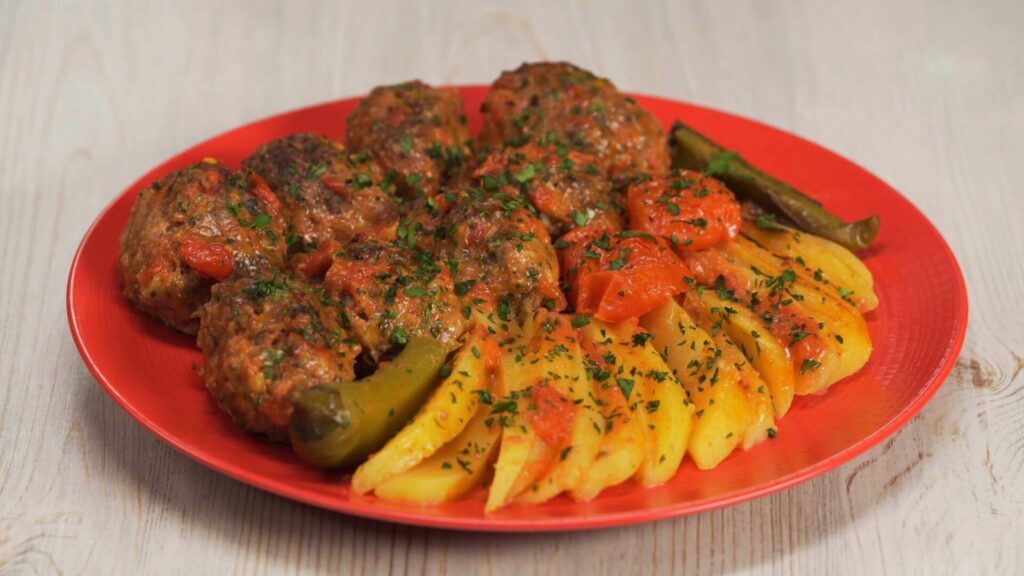 Smyrna meatballs, known as soutzoukakia Smyrneika or İzmir köfte is a Greek and Turkish dish of spicy oblong meatballs with cumin and garlic served in tomato sauce